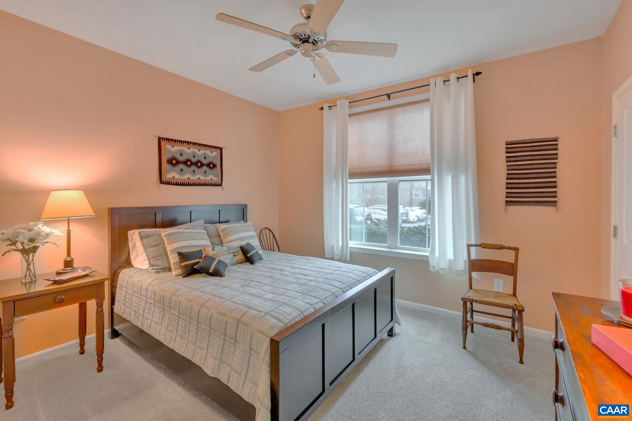 765 Walker Square, Unit 2D Charlottesville, VA 22903 - Photo 14 of 33 a bedroom with a bed and a table in it