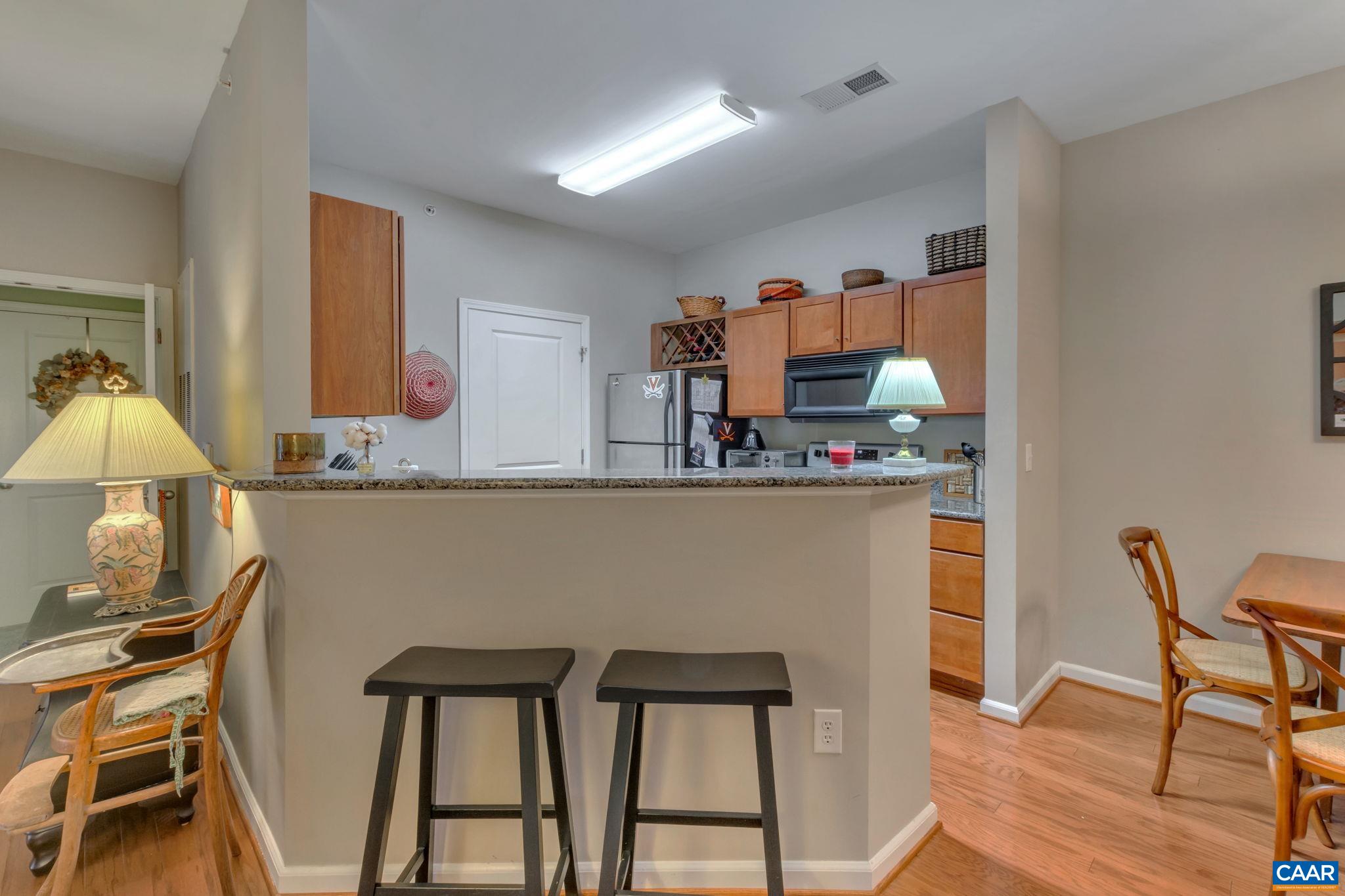765 Walker Square, Unit 2D Charlottesville, VA 22903 - Photo 5 of 33 a room with a table chairs and a wooden floor
