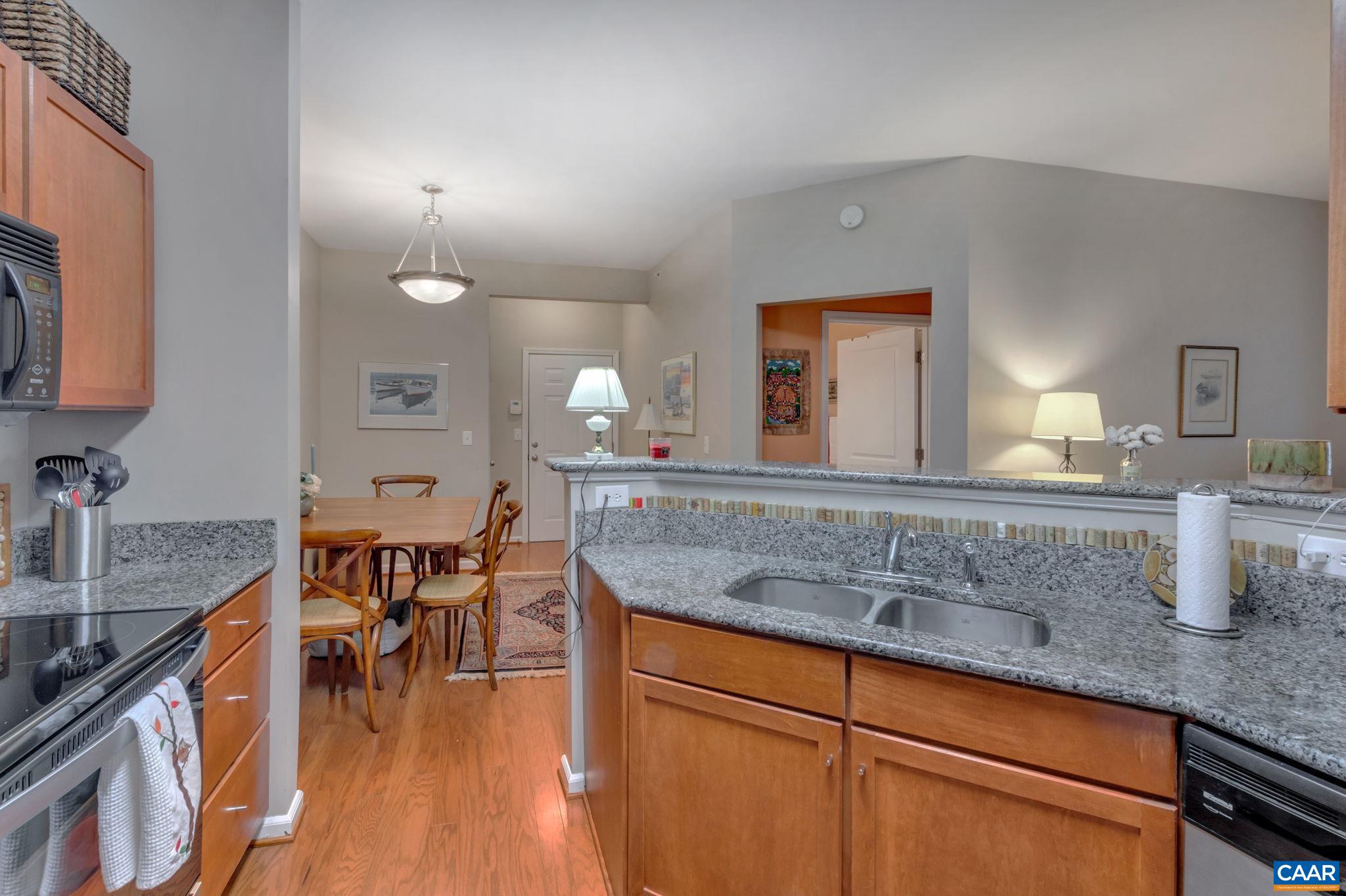 765 Walker Square, Unit 2D Charlottesville, VA 22903 - Photo 7 of 33 a kitchen with center island table and chairs