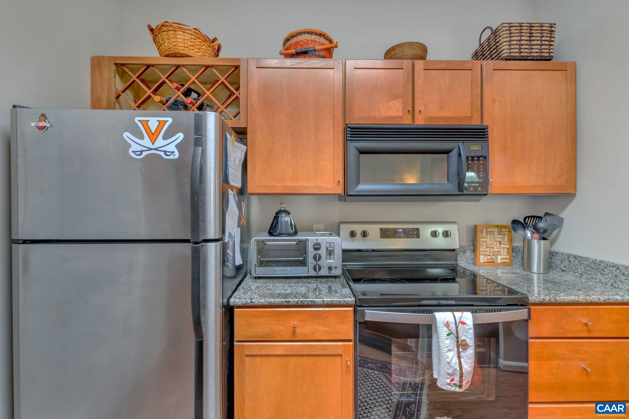 765 Walker Square, Unit 2D Charlottesville, VA 22903 - Photo 9 of 33 a kitchen with stainless steel appliances granite countertop a refrigerator and a microwave