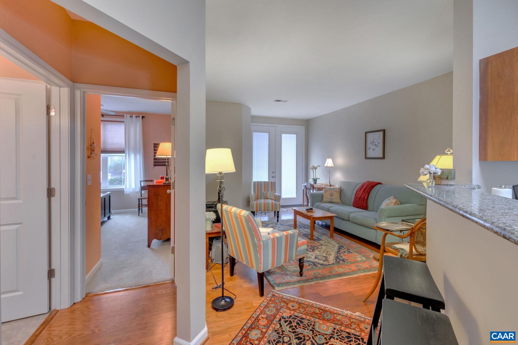 765 Walker Square, Unit 2D Charlottesville, VA 22903 - Photo 10 of 33 a living room with furniture and wooden floor