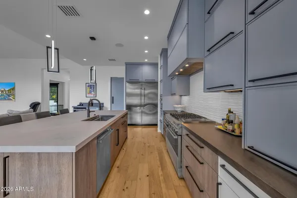 a kitchen with stainless steel appliances granite countertop a stove and a sink