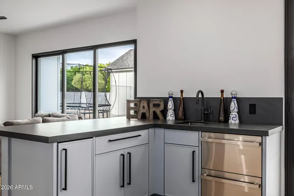 a kitchen with stainless steel appliances a refrigerator and a wooden floor