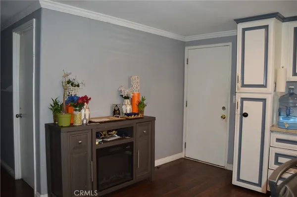 a view of a hallway with workspace and wooden floor