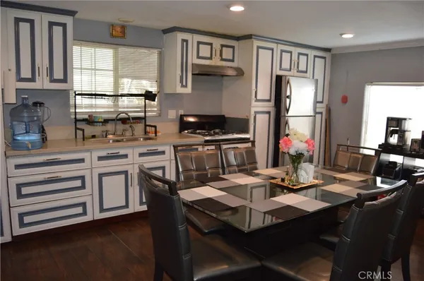 a kitchen with kitchen island a stove a sink and a refrigerator