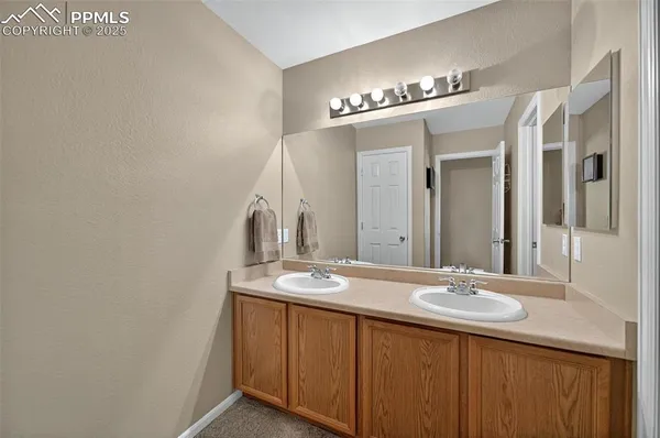 a bathroom with a double vanity sink and a mirror