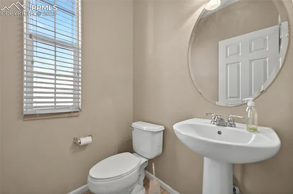 a bathroom with a toilet a sink and a mirror