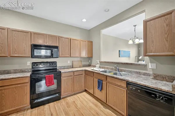 a kitchen with stainless steel appliances granite countertop a sink stove and microwave