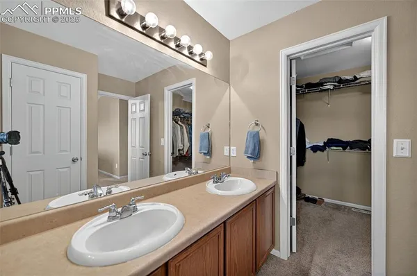 a bathroom with a sink double vanity and a mirror