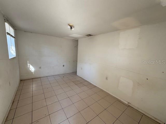 1672 10th Street Sarasota, FL 34236 - Photo 13 of 24 an empty room with white walls and tiles