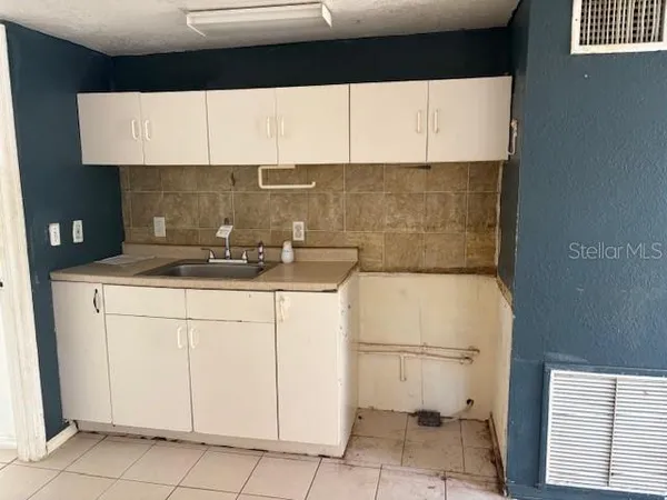 a kitchen with a sink and cabinets