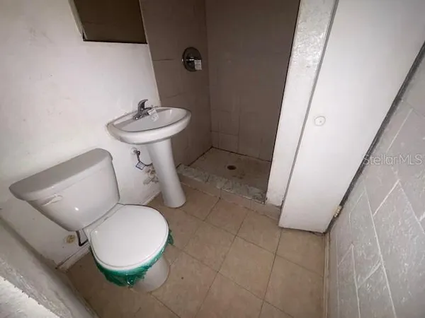 a bathroom with a sink toilet and a mirror