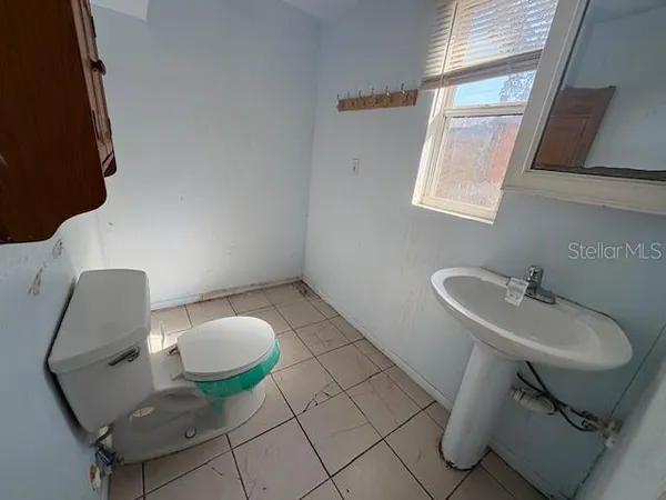 a bathroom with a sink a toilet and a shower