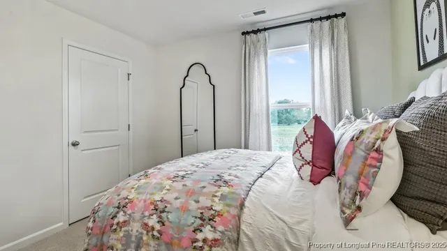 a bedroom with a bed and a window