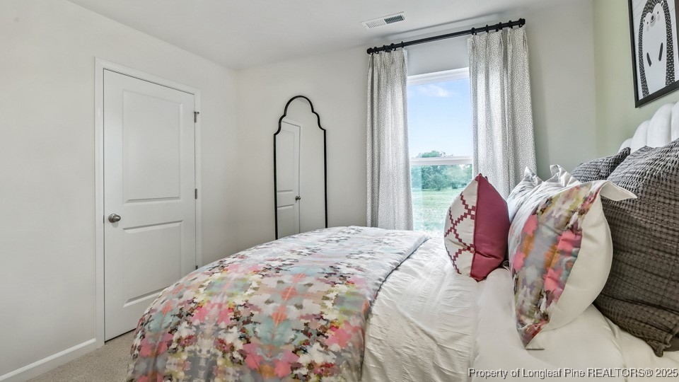 45 Mercer Way Spring Lake, NC 28390 - Photo 21 of 35 a bedroom with a bed and a window