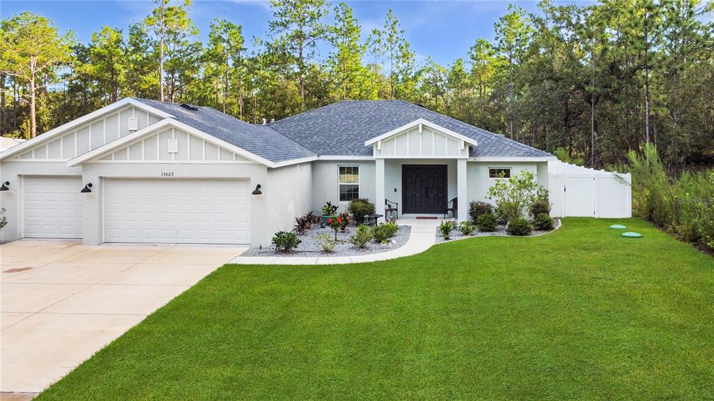 13023 Downy Woodpecker Road Weeki Wachee, FL 34614 - Photo 5 of 43 a front view of a house with a yard and porch