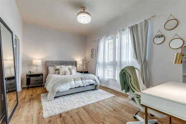 a bedroom with a bed and a chandelier