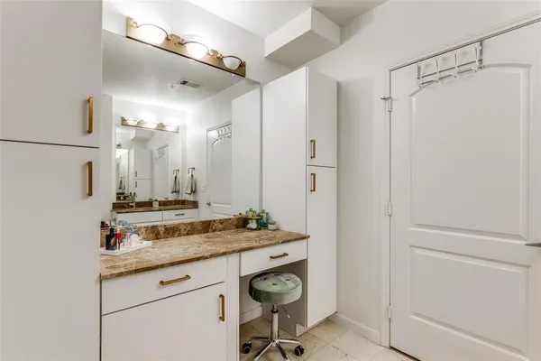 a view of bathroom with a sink and mirror
