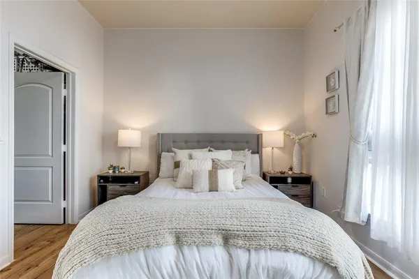 a bedroom with a bed and wooden floor