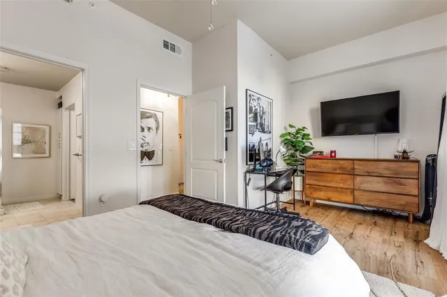 a bedroom with a bed and flat screen tv