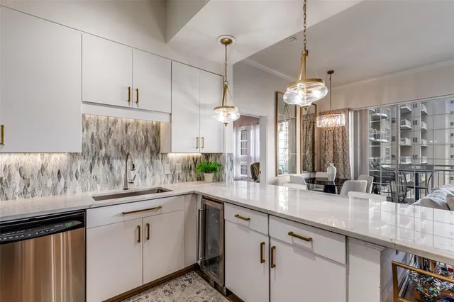 a kitchen with kitchen island granite countertop a sink cabinets and window