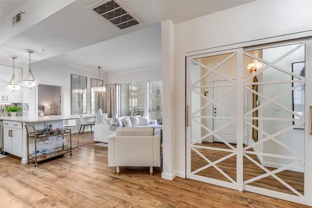 a living room with furniture a wooden floor and a chandelier