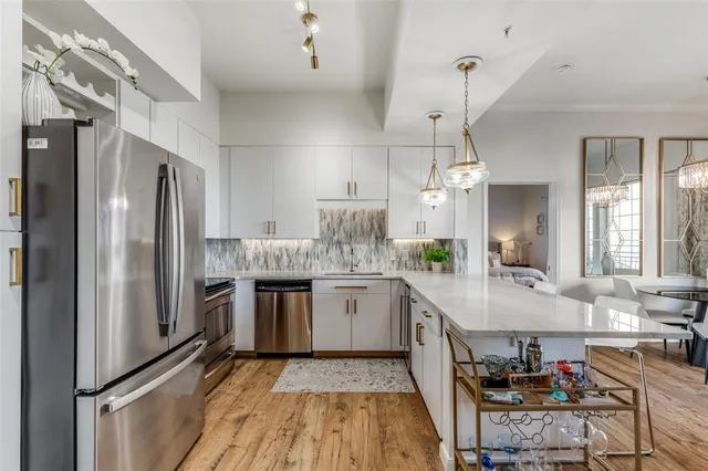 a kitchen with stainless steel appliances granite countertop a refrigerator and a stove