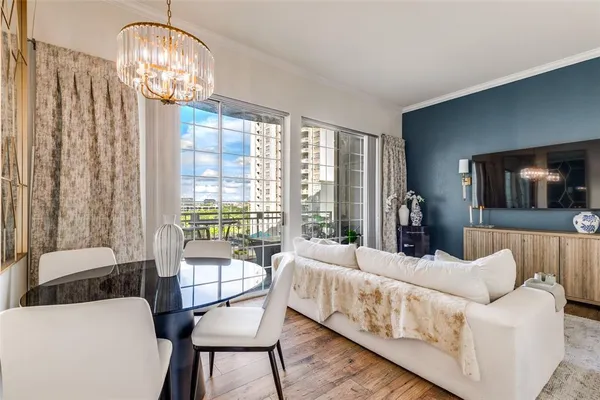 a bedroom with furniture and a large window