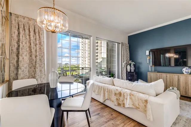 a bedroom with furniture and a large window