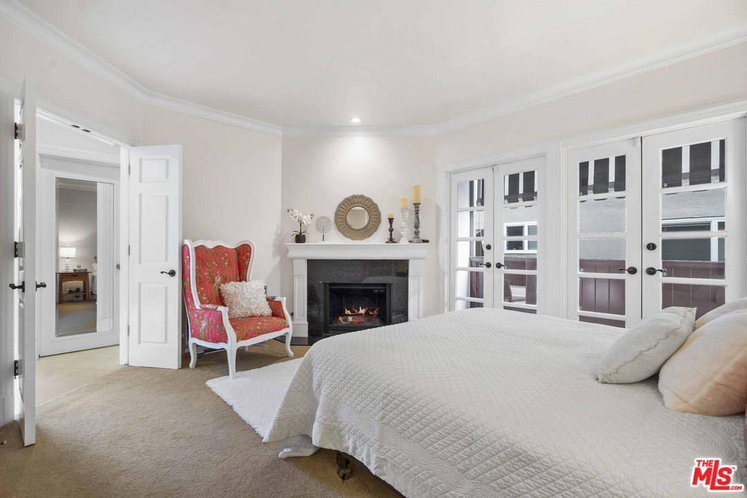 22630 Pacific Coast Highway Malibu, CA 90265 - Photo 11 of 24 a bedroom with a bed and a fireplace