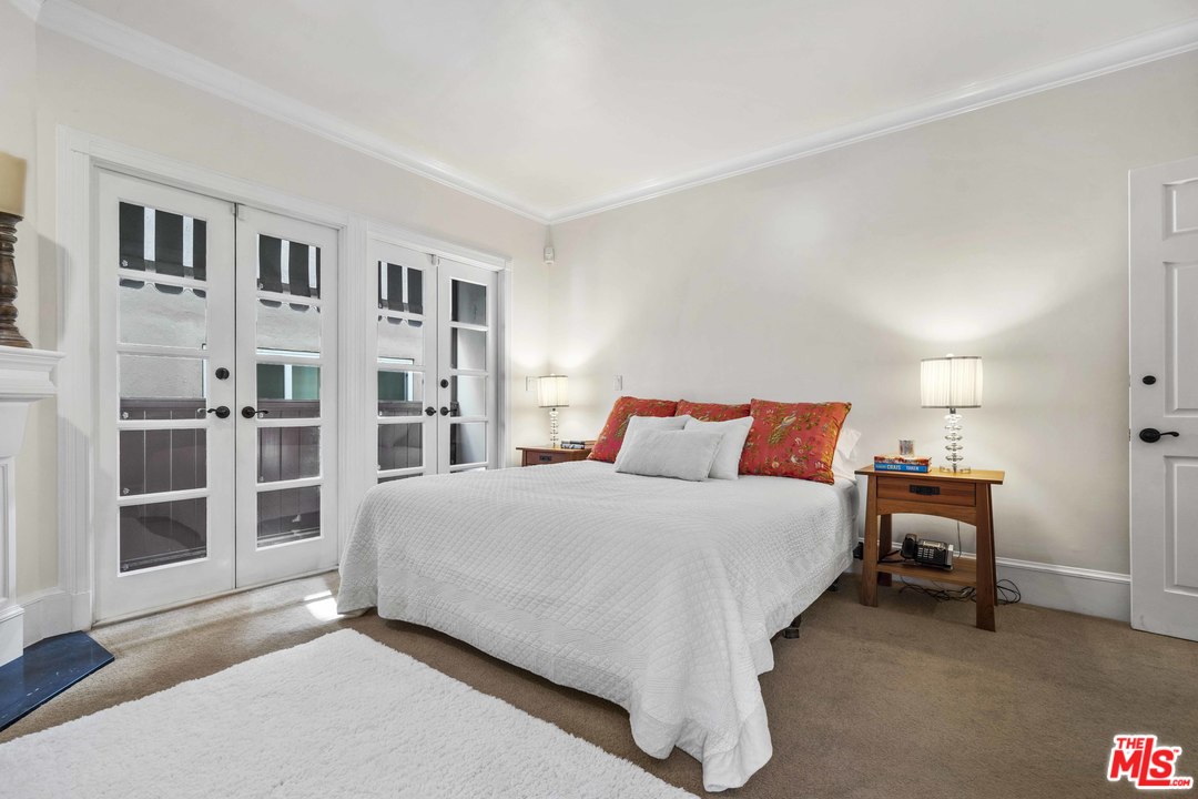 22630 Pacific Coast Highway Malibu, CA 90265 - Photo 12 of 24 a bedroom with a bed and a cabinets