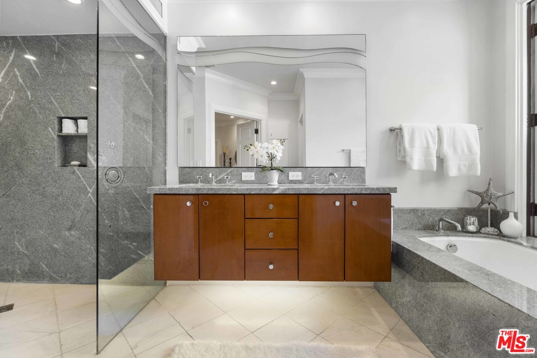 22630 Pacific Coast Highway Malibu, CA 90265 - Photo 13 of 24 a bathroom with a granite countertop sink a mirror and a shower