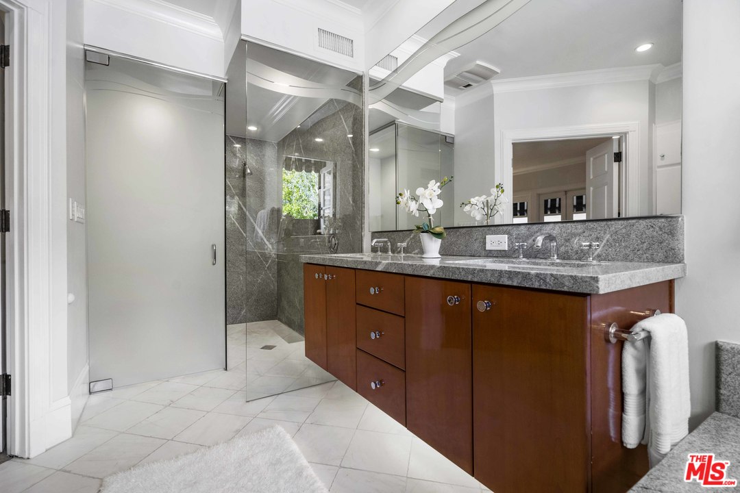 22630 Pacific Coast Highway Malibu, CA 90265 - Photo 15 of 24 a bathroom with a granite countertop sink a mirror and a shower