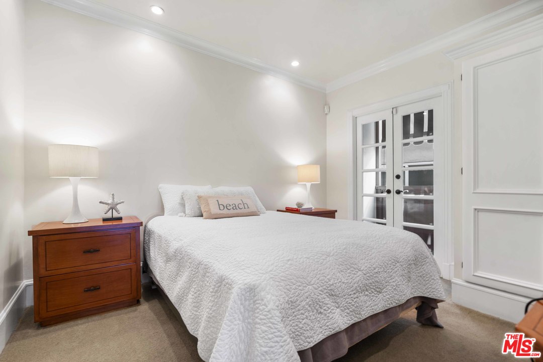 22630 Pacific Coast Highway Malibu, CA 90265 - Photo 16 of 24 a bedroom with a bed and a cabinets