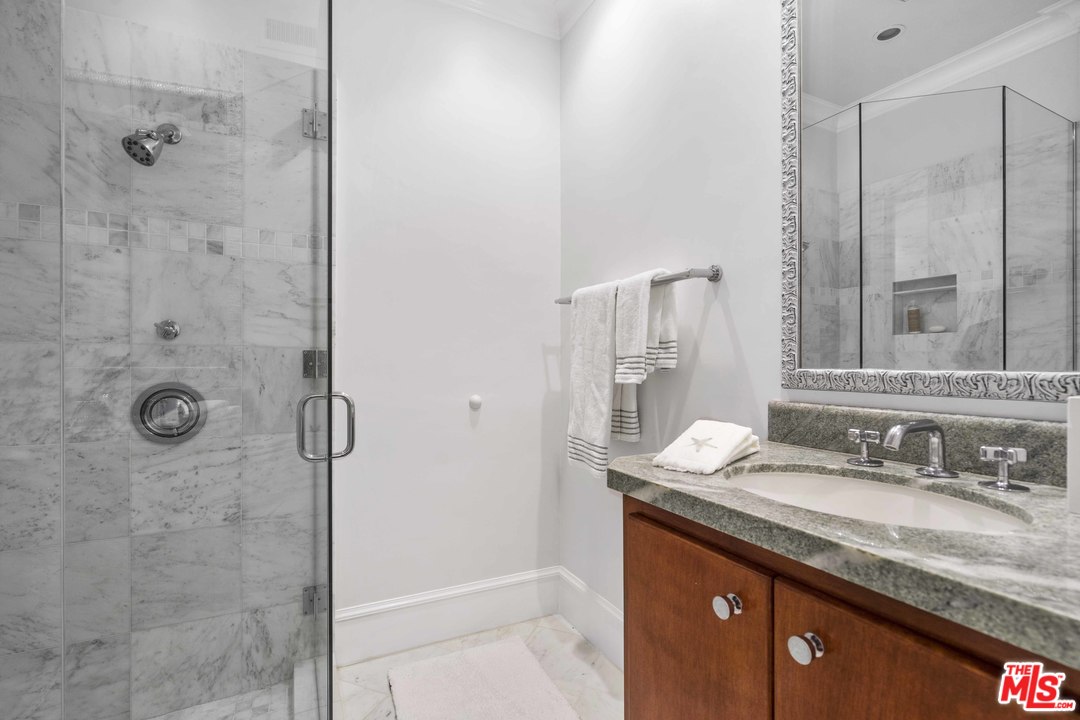 22630 Pacific Coast Highway Malibu, CA 90265 - Photo 17 of 24 a bathroom with a granite countertop shower sink and mirror