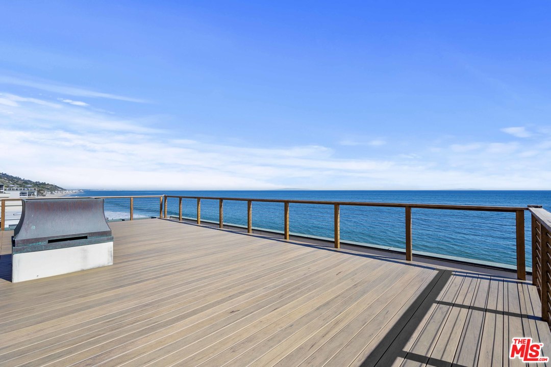 22630 Pacific Coast Highway Malibu, CA 90265 - Photo 19 of 24 a view of balcony with floor to ceiling window and wooden floor