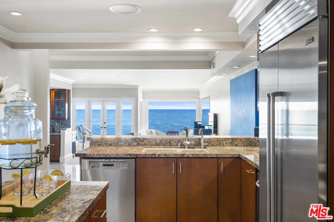 22630 Pacific Coast Highway Malibu, CA 90265 - Photo 8 of 24 a kitchen with a sink refrigerator and cabinets