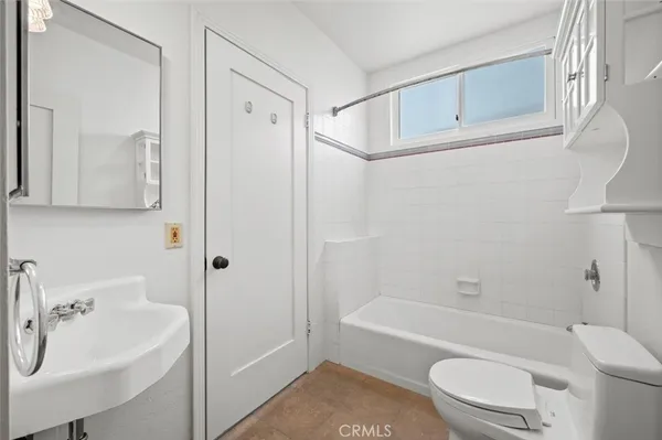 a bathroom with a sink a toilet and a bathtub
