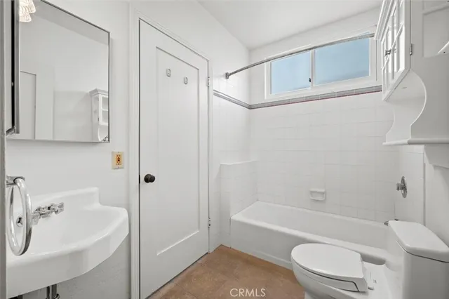 a bathroom with a sink a toilet and a bathtub