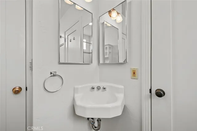 a bathroom with a sink a mirror and a shower