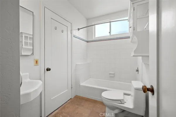 a bathroom with a granite countertop toilet a sink and bathtub