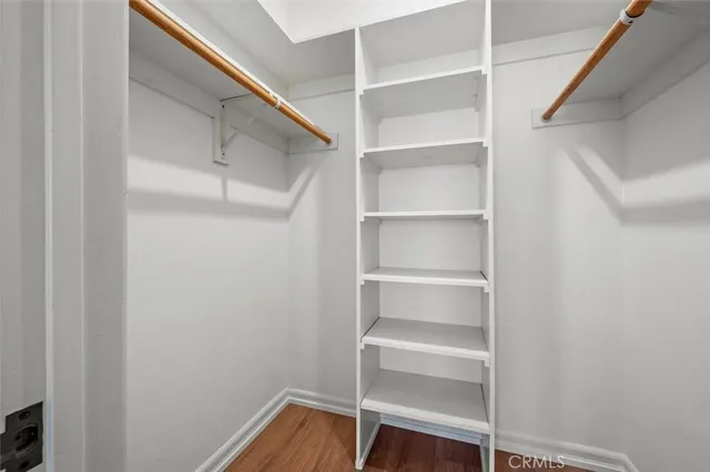 a view of walk in closet with empty racks