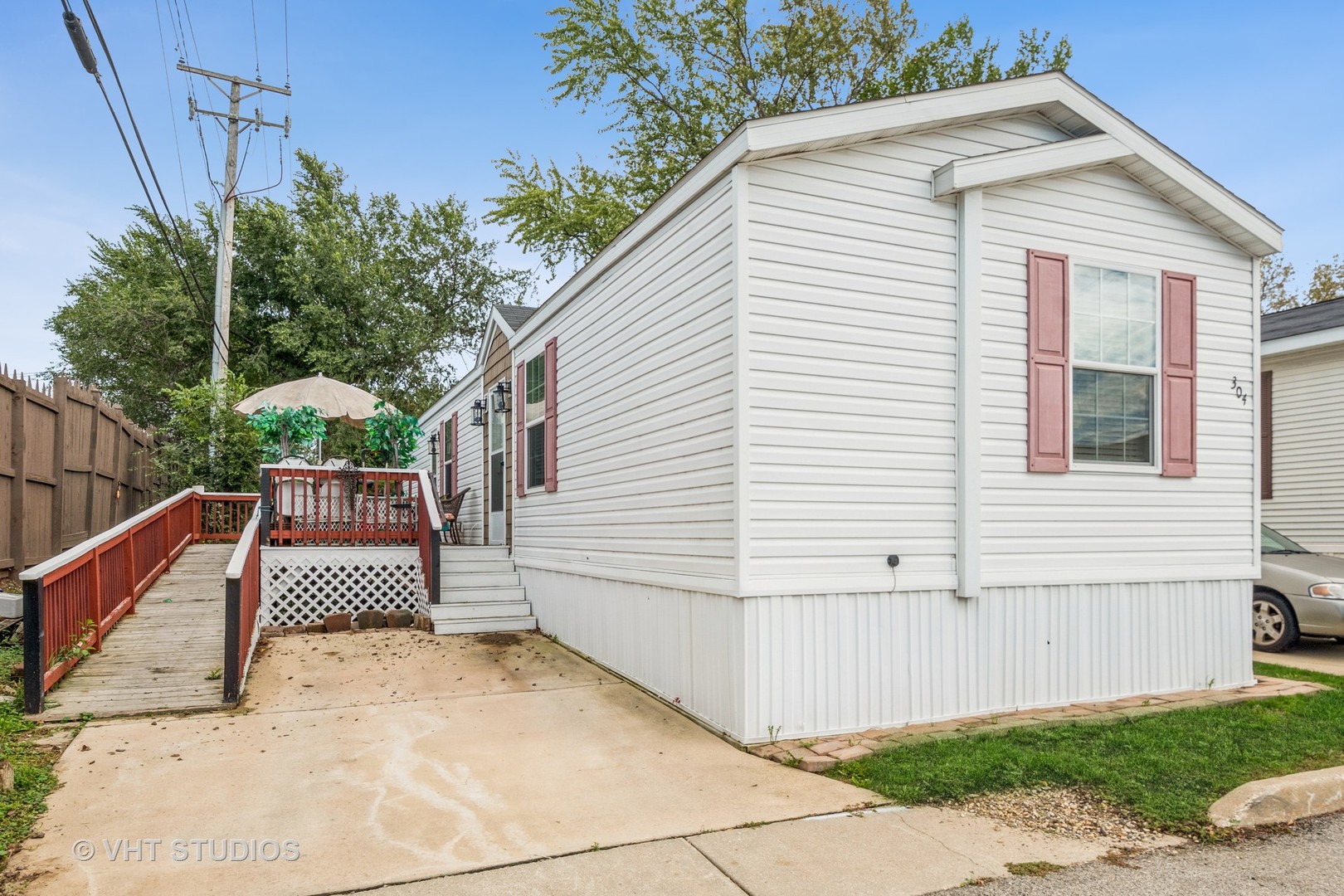 304 3rd Street Northfield, IL 60093 - Photo 2 of 14 a white house with a small yard and wooden fence