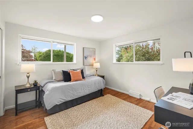 a bedroom with two beds and a window