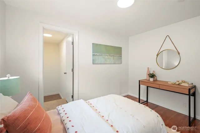 a bedroom with a bed and a mirror