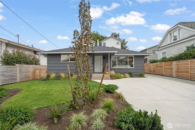 a front view of a house with a garden