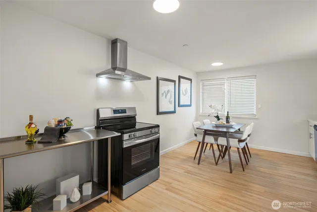 a kitchen with stainless steel appliances a stove top oven and cabinets