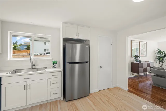 a kitchen with a refrigerator and a sink