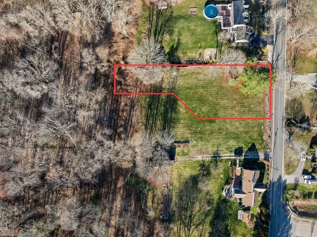 an aerial view of residential house with outdoor space and trees