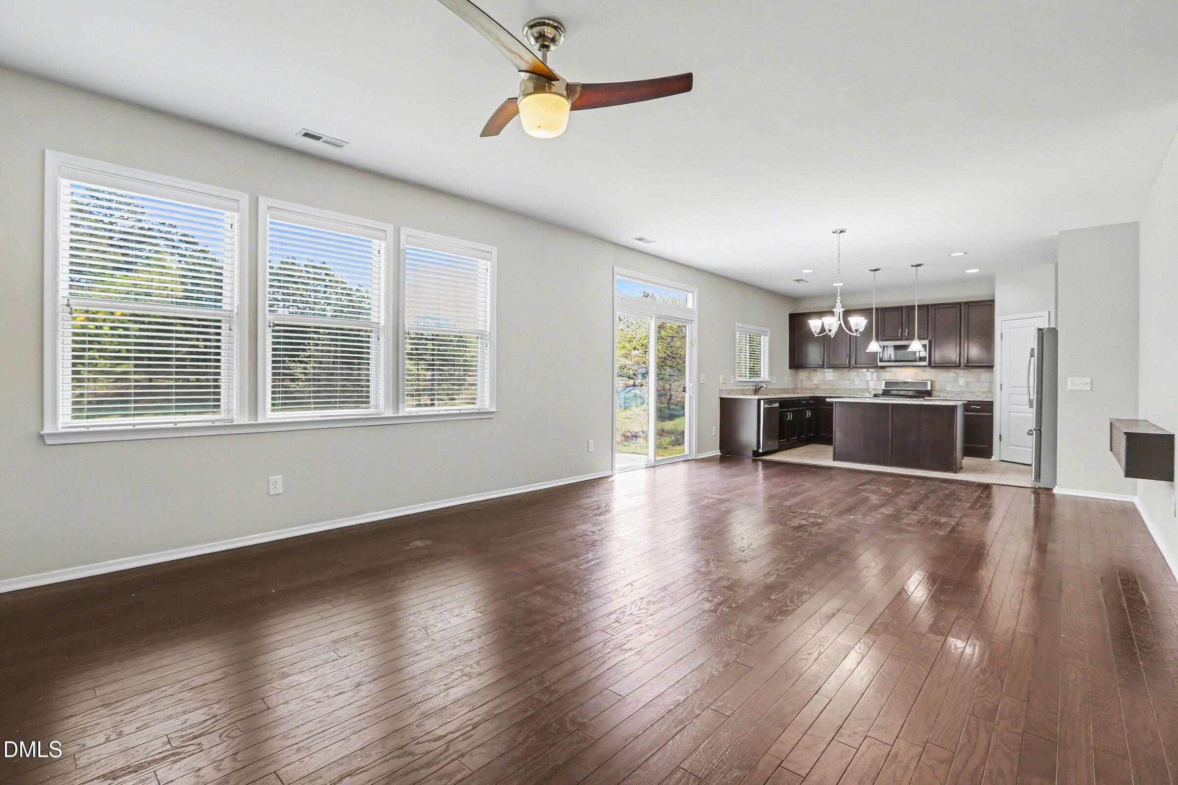 132 Daneborg Road Durham, NC 27703 - Photo 12 of 37 a view of a kitchen with a stove cabinets wooden floor and a window